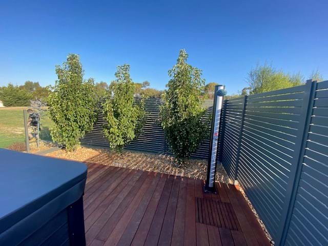 combination fence Slat and Semi Frameless Semi Frameless posts powder coated woodland grey to match the Slat Fence