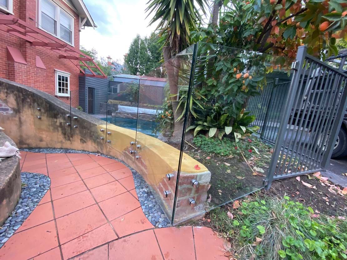 Combination - Standoff Panels on a curved wall with Woodland Grey Aluminium Fence